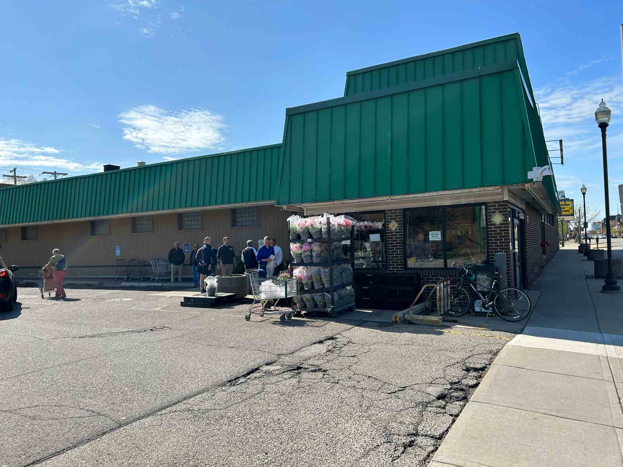 Front of Hollywood Market store without sign, view from parking lot.