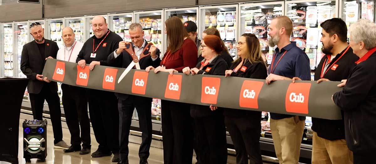 Cub employees cut ribbon for new wine and spirit store